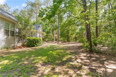 Tucked behind a canopy of mature trees, this beautifully on Oak Grove Island Golf and Country Club in Georgia - for sale on GolfHomes.com, golf home, golf lot