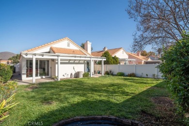 This darling home adorns a winding street in the tightly-knit on Menifee Lakes Country Club - Lakes in California - for sale on GolfHomes.com, golf home, golf lot