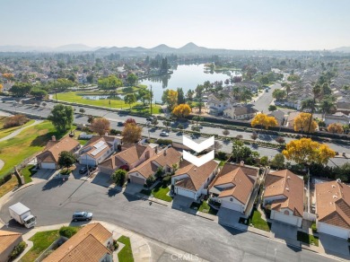 This darling home adorns a winding street in the tightly-knit on Menifee Lakes Country Club - Lakes in California - for sale on GolfHomes.com, golf home, golf lot