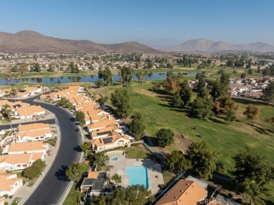 This darling home adorns a winding street in the tightly-knit on Menifee Lakes Country Club - Lakes in California - for sale on GolfHomes.com, golf home, golf lot