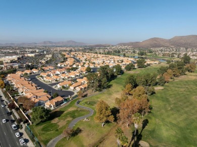 This darling home adorns a winding street in the tightly-knit on Menifee Lakes Country Club - Lakes in California - for sale on GolfHomes.com, golf home, golf lot