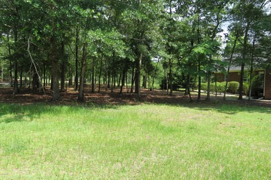 This lovely wooded, over a half acre, lot overlooks the 4th tee on Carolina National Golf Club in North Carolina - for sale on GolfHomes.com, golf home, golf lot