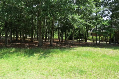 This lovely wooded, over a half acre, lot overlooks the 4th tee on Carolina National Golf Club in North Carolina - for sale on GolfHomes.com, golf home, golf lot