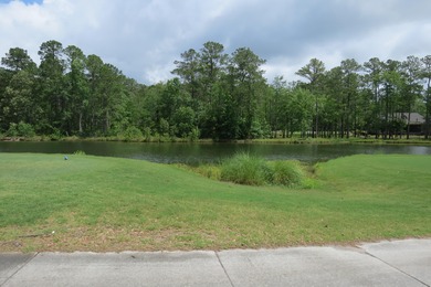 This lovely wooded, over a half acre, lot overlooks the 4th tee on Carolina National Golf Club in North Carolina - for sale on GolfHomes.com, golf home, golf lot
