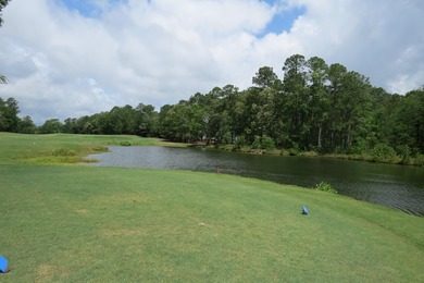 This lovely wooded, over a half acre, lot overlooks the 4th tee on Carolina National Golf Club in North Carolina - for sale on GolfHomes.com, golf home, golf lot