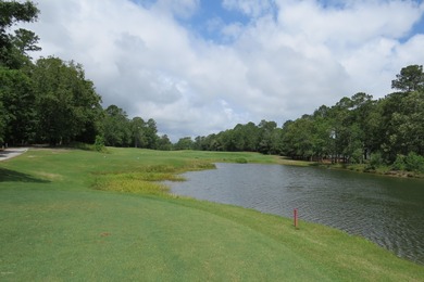 This lovely wooded, over a half acre, lot overlooks the 4th tee on Carolina National Golf Club in North Carolina - for sale on GolfHomes.com, golf home, golf lot