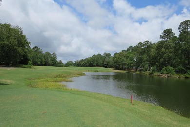 This lovely wooded, over a half acre, lot overlooks the 4th tee on Carolina National Golf Club in North Carolina - for sale on GolfHomes.com, golf home, golf lot