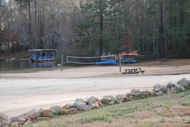 Welcome to the Lake Life! This large, beautiful, and wooded on River Golf and Country Club at Lake Royale in North Carolina - for sale on GolfHomes.com, golf home, golf lot