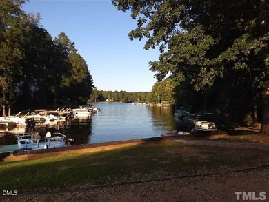 Welcome to the Lake Life! This large, beautiful, and wooded on River Golf and Country Club at Lake Royale in North Carolina - for sale on GolfHomes.com, golf home, golf lot