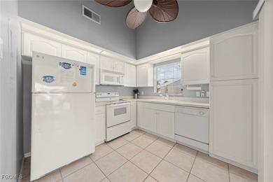 SUNLIGHT POURS IN OFF THE GLISTENING LAKE. Second floor end unit on Gulf Harbour Yacht and Country Club in Florida - for sale on GolfHomes.com, golf home, golf lot