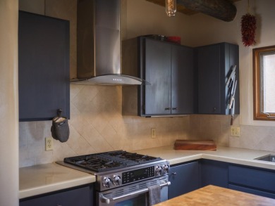 Discover unparalleled beauty and comfort in this exquisite on Taos Country Club in New Mexico - for sale on GolfHomes.com, golf home, golf lot