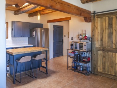 Discover unparalleled beauty and comfort in this exquisite on Taos Country Club in New Mexico - for sale on GolfHomes.com, golf home, golf lot