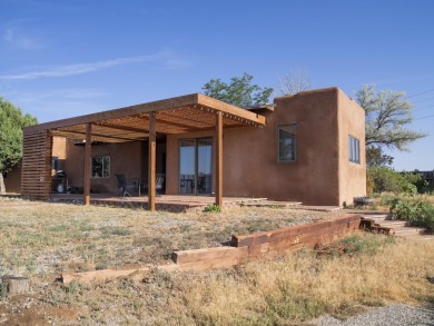 Discover unparalleled beauty and comfort in this exquisite on Taos Country Club in New Mexico - for sale on GolfHomes.com, golf home, golf lot