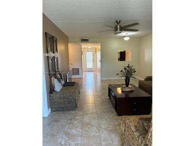 Elevated living meets total convenience in this charming on Sunrise Lakes Phase IV Golf Course in Florida - for sale on GolfHomes.com, golf home, golf lot