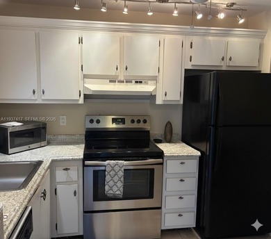 Elevated living meets total convenience in this charming on Sunrise Lakes Phase IV Golf Course in Florida - for sale on GolfHomes.com, golf home, golf lot