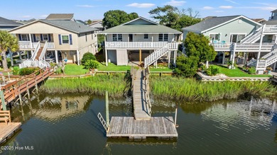 Charming Beach Cottage on Canal Lot with Boat Dock This is a on Sea Trail Golf Resort in North Carolina - for sale on GolfHomes.com, golf home, golf lot