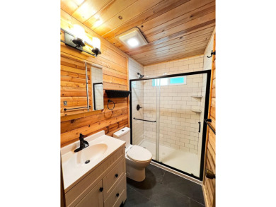 Discover this updated cabin retreat steps from golfing, fishing on El Valle Escondido Golf Course in New Mexico - for sale on GolfHomes.com, golf home, golf lot