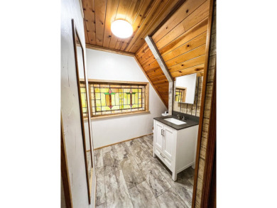 Discover this updated cabin retreat steps from golfing, fishing on El Valle Escondido Golf Course in New Mexico - for sale on GolfHomes.com, golf home, golf lot