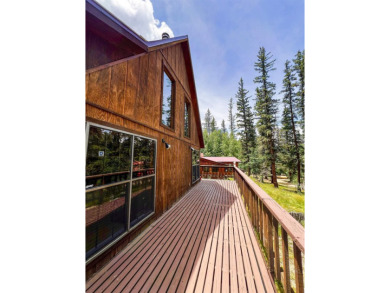 Discover this updated cabin retreat steps from golfing, fishing on El Valle Escondido Golf Course in New Mexico - for sale on GolfHomes.com, golf home, golf lot