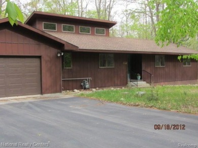 Welcome to 4010 Owl. This custom built Mahalak contemporary on Lost Lake Woods Club in Michigan - for sale on GolfHomes.com, golf home, golf lot