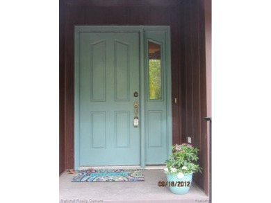Welcome to 4010 Owl. This custom built Mahalak contemporary on Lost Lake Woods Club in Michigan - for sale on GolfHomes.com, golf home, golf lot