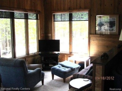 Welcome to 4010 Owl. This custom built Mahalak contemporary on Lost Lake Woods Club in Michigan - for sale on GolfHomes.com, golf home, golf lot