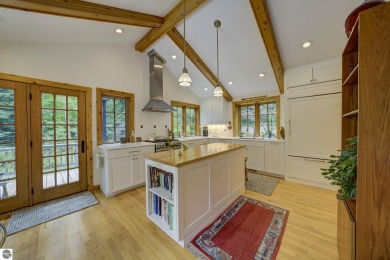 Nestled on an incredibly rare, private 2.47 wooded acres in on Leland Country Club in Michigan - for sale on GolfHomes.com, golf home, golf lot