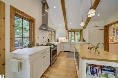 Nestled on an incredibly rare, private 2.47 wooded acres in on Leland Country Club in Michigan - for sale on GolfHomes.com, golf home, golf lot