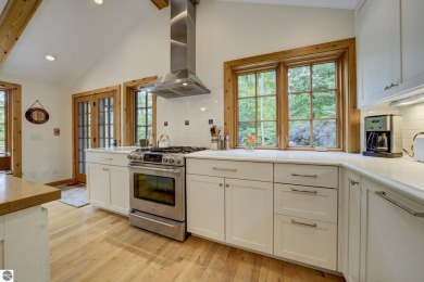 Nestled on an incredibly rare, private 2.47 wooded acres in on Leland Country Club in Michigan - for sale on GolfHomes.com, golf home, golf lot