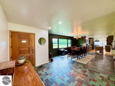 Discover 2,200 sq. ft. of luxurious, single-level living in this on Pine River Country Club in Michigan - for sale on GolfHomes.com, golf home, golf lot