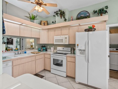 This beautifully maintained concrete block and stucco 'Doral' on Royal Oaks Golf Club in Florida - for sale on GolfHomes.com, golf home, golf lot