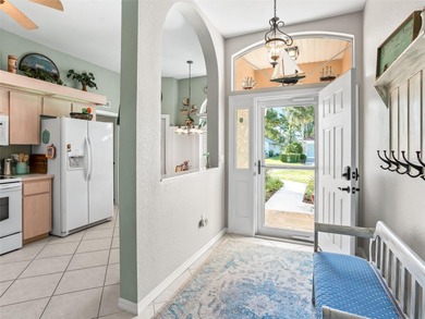 This beautifully maintained concrete block and stucco 'Doral' on Royal Oaks Golf Club in Florida - for sale on GolfHomes.com, golf home, golf lot