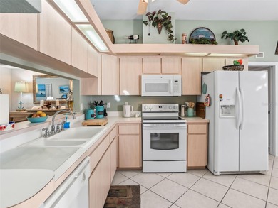 This beautifully maintained concrete block and stucco 'Doral' on Royal Oaks Golf Club in Florida - for sale on GolfHomes.com, golf home, golf lot