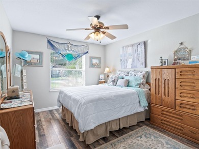 This beautifully maintained concrete block and stucco 'Doral' on Royal Oaks Golf Club in Florida - for sale on GolfHomes.com, golf home, golf lot