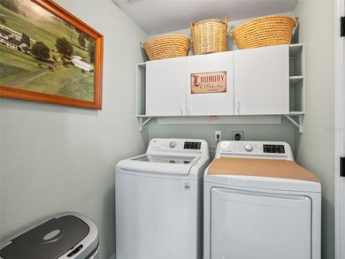 This beautifully maintained concrete block and stucco 'Doral' on Royal Oaks Golf Club in Florida - for sale on GolfHomes.com, golf home, golf lot