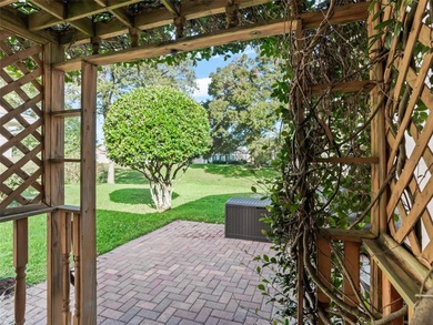 This beautifully maintained concrete block and stucco 'Doral' on Royal Oaks Golf Club in Florida - for sale on GolfHomes.com, golf home, golf lot