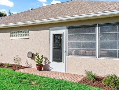 This beautifully maintained concrete block and stucco 'Doral' on Royal Oaks Golf Club in Florida - for sale on GolfHomes.com, golf home, golf lot