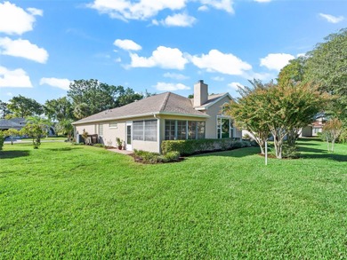 This beautifully maintained concrete block and stucco 'Doral' on Royal Oaks Golf Club in Florida - for sale on GolfHomes.com, golf home, golf lot
