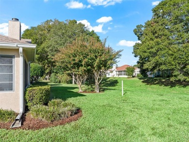 This beautifully maintained concrete block and stucco 'Doral' on Royal Oaks Golf Club in Florida - for sale on GolfHomes.com, golf home, golf lot