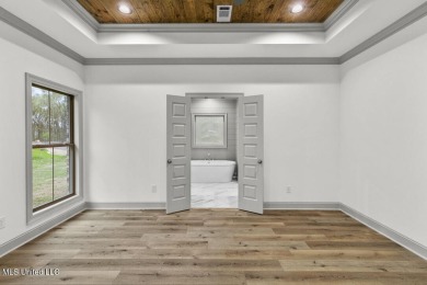 Welcome to this beautiful 4 bedroom, 2.5 bath home located in on Lake Caroline Golf Club in Mississippi - for sale on GolfHomes.com, golf home, golf lot