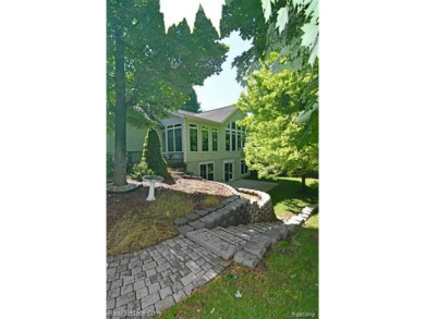 Step inside and discover a thoughtfully designed split ranch on Lost Lake Woods Club in Michigan - for sale on GolfHomes.com, golf home, golf lot