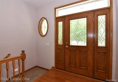 Step inside and discover a thoughtfully designed split ranch on Lost Lake Woods Club in Michigan - for sale on GolfHomes.com, golf home, golf lot