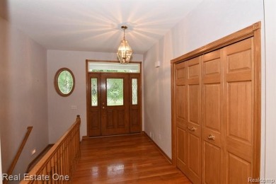 Step inside and discover a thoughtfully designed split ranch on Lost Lake Woods Club in Michigan - for sale on GolfHomes.com, golf home, golf lot