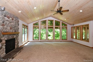 Step inside and discover a thoughtfully designed split ranch on Lost Lake Woods Club in Michigan - for sale on GolfHomes.com, golf home, golf lot
