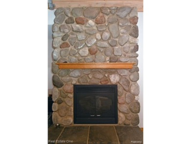 Step inside and discover a thoughtfully designed split ranch on Lost Lake Woods Club in Michigan - for sale on GolfHomes.com, golf home, golf lot