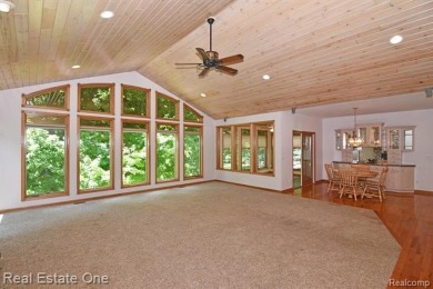 Step inside and discover a thoughtfully designed split ranch on Lost Lake Woods Club in Michigan - for sale on GolfHomes.com, golf home, golf lot