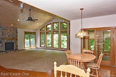 Step inside and discover a thoughtfully designed split ranch on Lost Lake Woods Club in Michigan - for sale on GolfHomes.com, golf home, golf lot