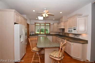 Step inside and discover a thoughtfully designed split ranch on Lost Lake Woods Club in Michigan - for sale on GolfHomes.com, golf home, golf lot