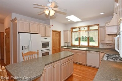 Step inside and discover a thoughtfully designed split ranch on Lost Lake Woods Club in Michigan - for sale on GolfHomes.com, golf home, golf lot