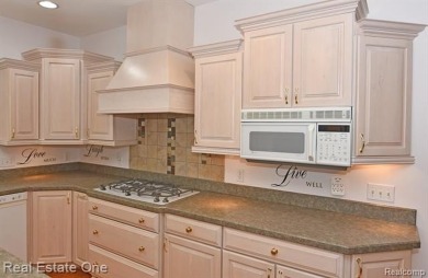 Step inside and discover a thoughtfully designed split ranch on Lost Lake Woods Club in Michigan - for sale on GolfHomes.com, golf home, golf lot